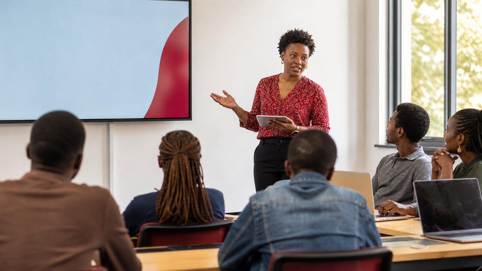African lecturer teaching students in a modern classroom