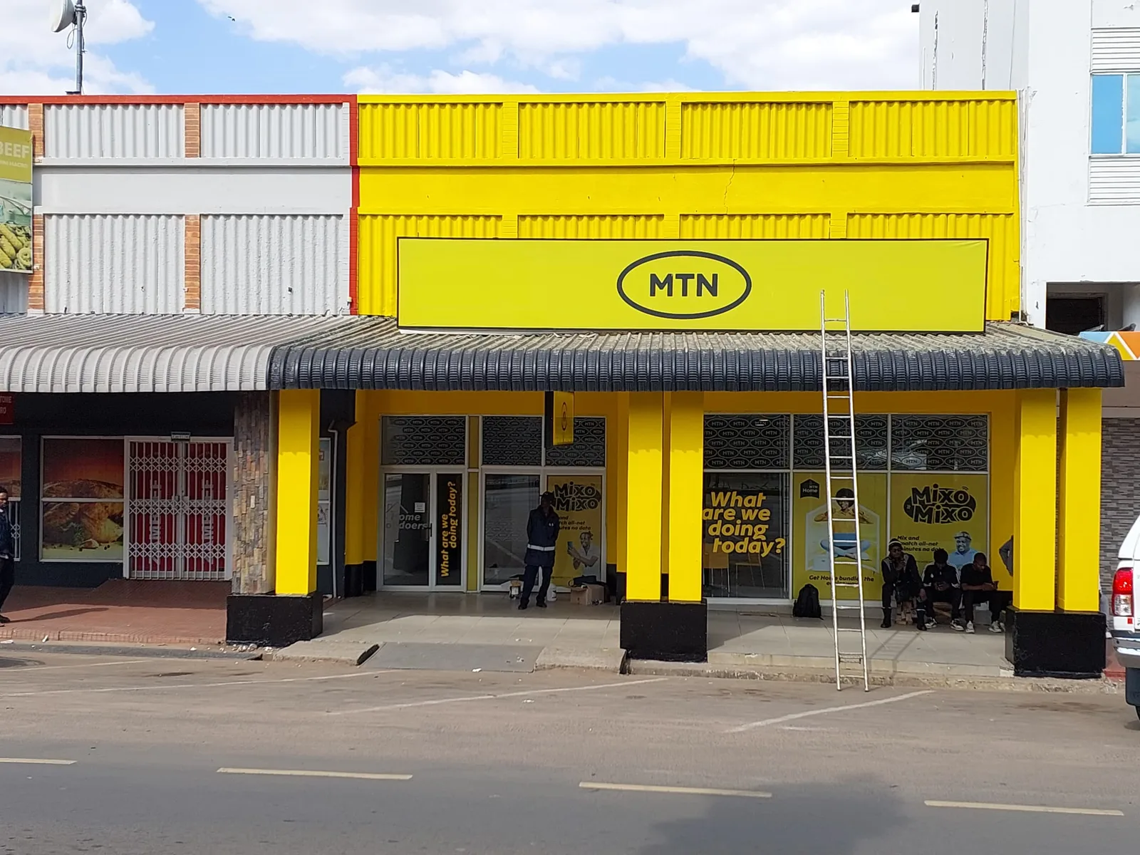 Completed yellow MTN retail storefront branding in Zambia