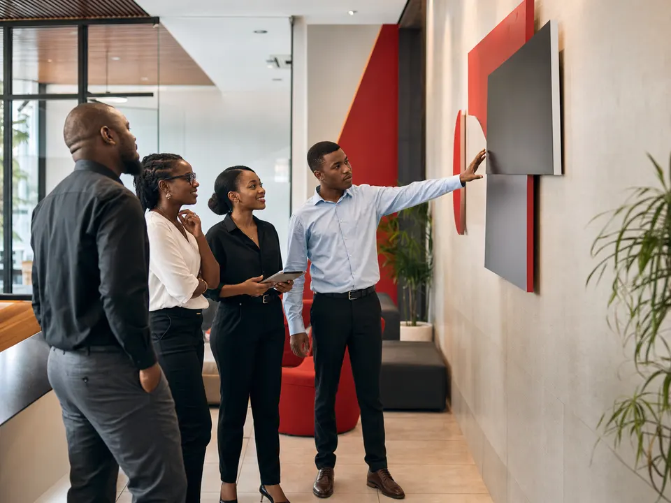 African branding team reviewing corporate reception graphics