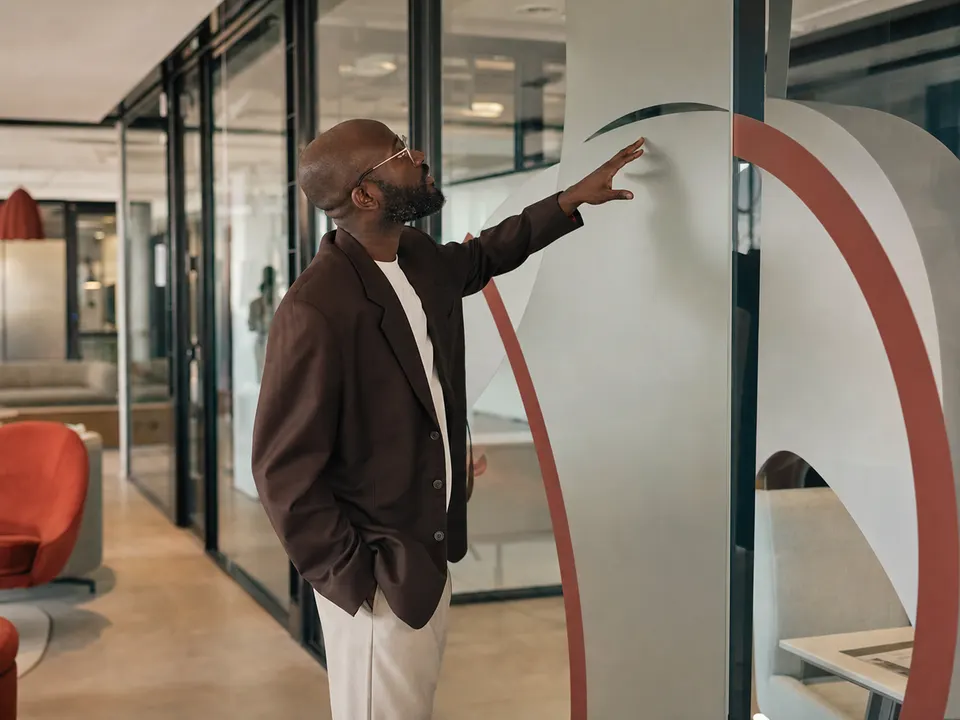African creative lead inspecting newly branded office graphics